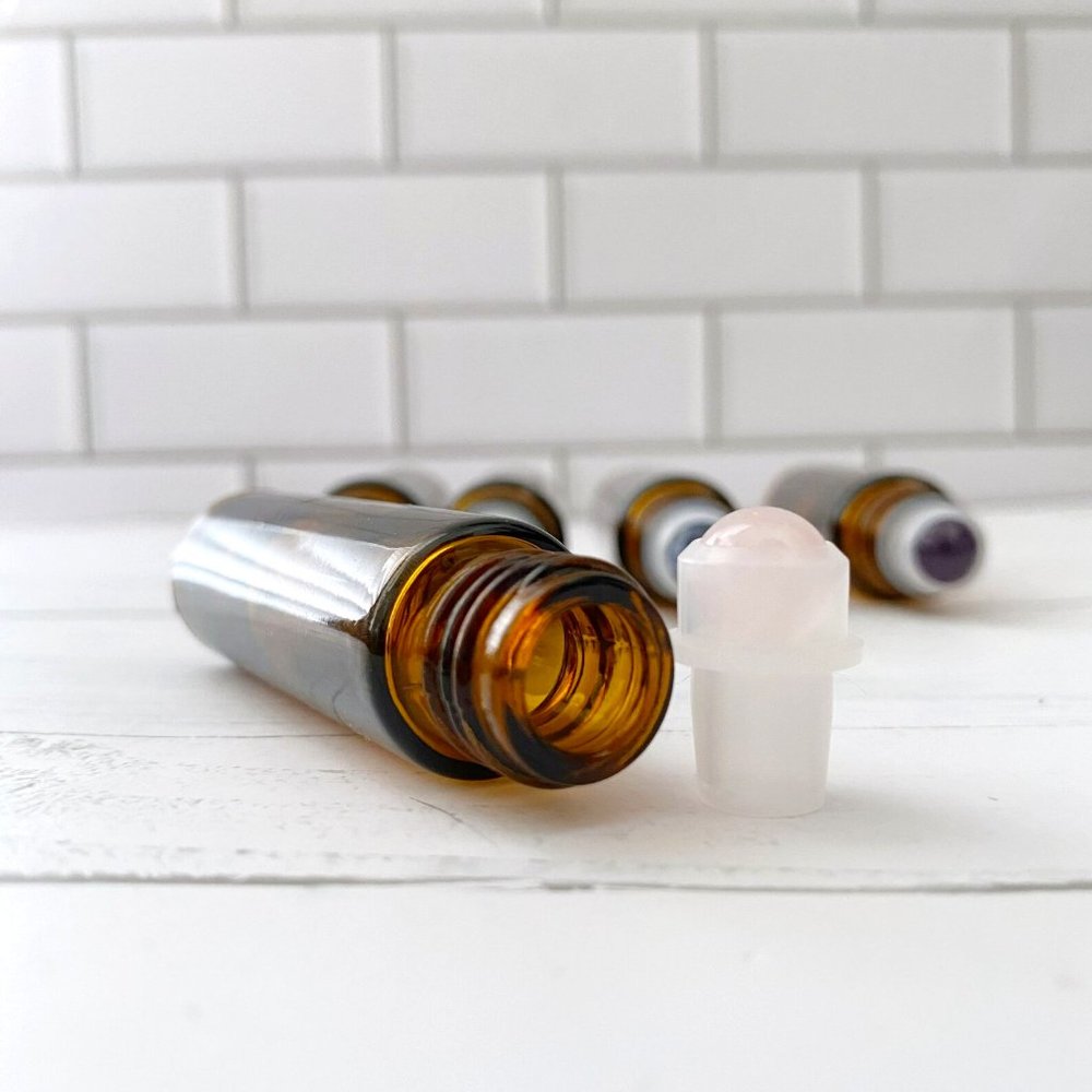 10 count 10ml empty amber essential oil bottles w/ rose quartz roller balls.